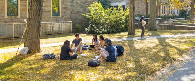A class meets outside Ives Hall on a warm fall day.